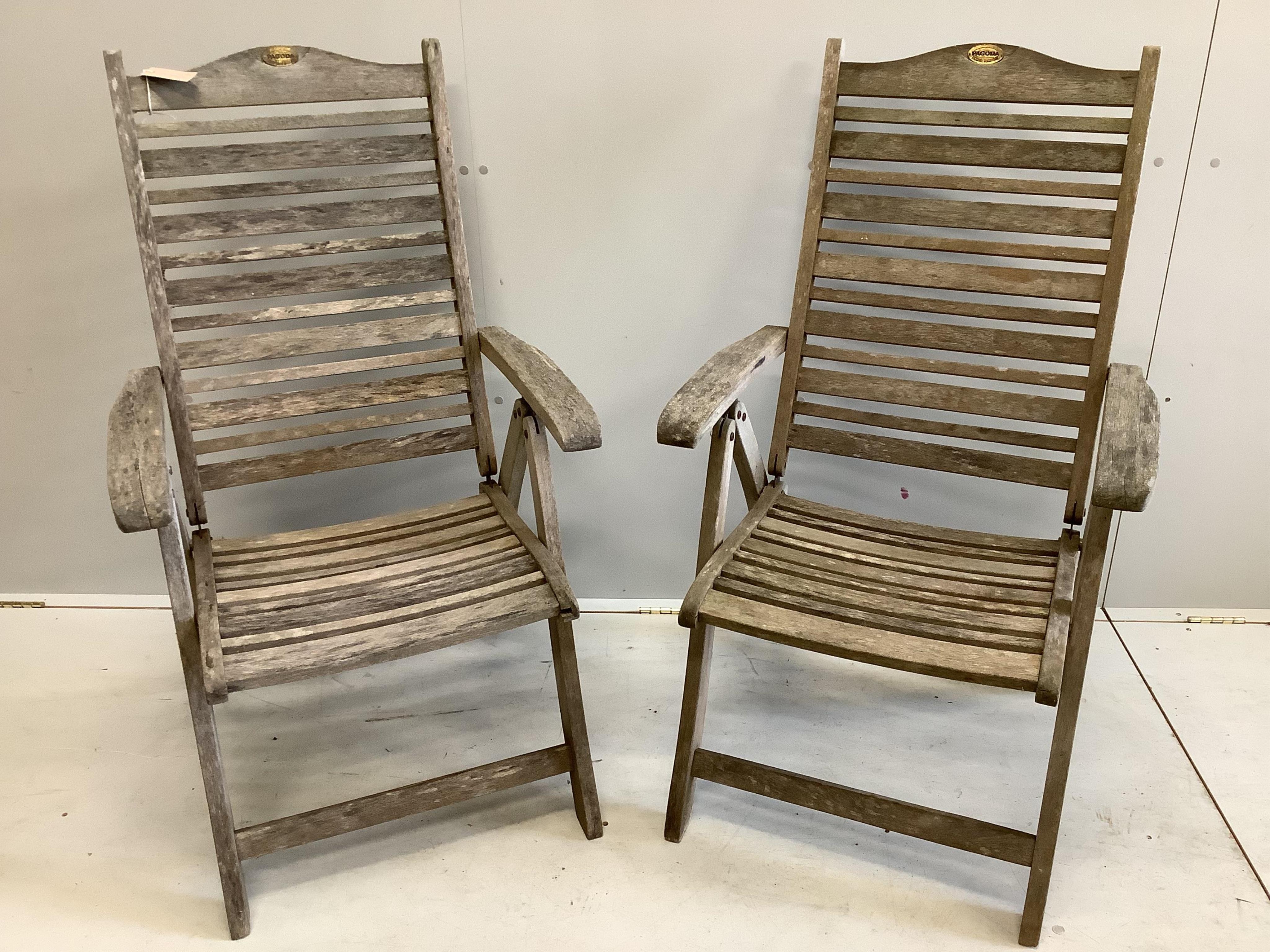 A pair of 'Pagoda' teak folding garden chairs and cushions. Condition - weathered